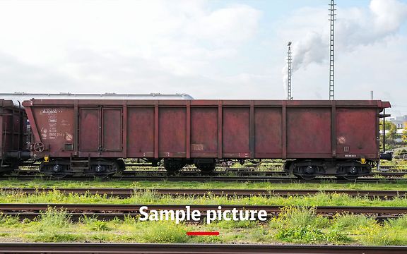 A goods train with brown wagons and the signature Sample picture