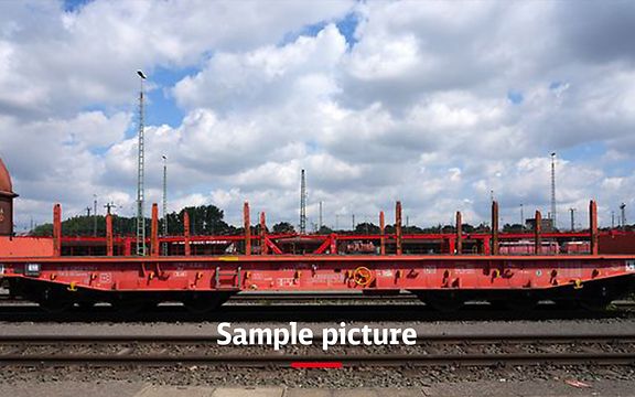 A freight train with red wagons and the signature Sample picture